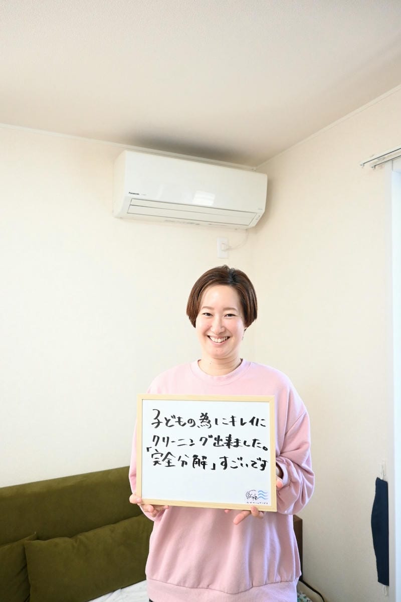O様がホワイトボードを持って笑顔な様子