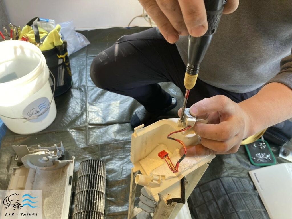 エアコンのモーターを外している様子