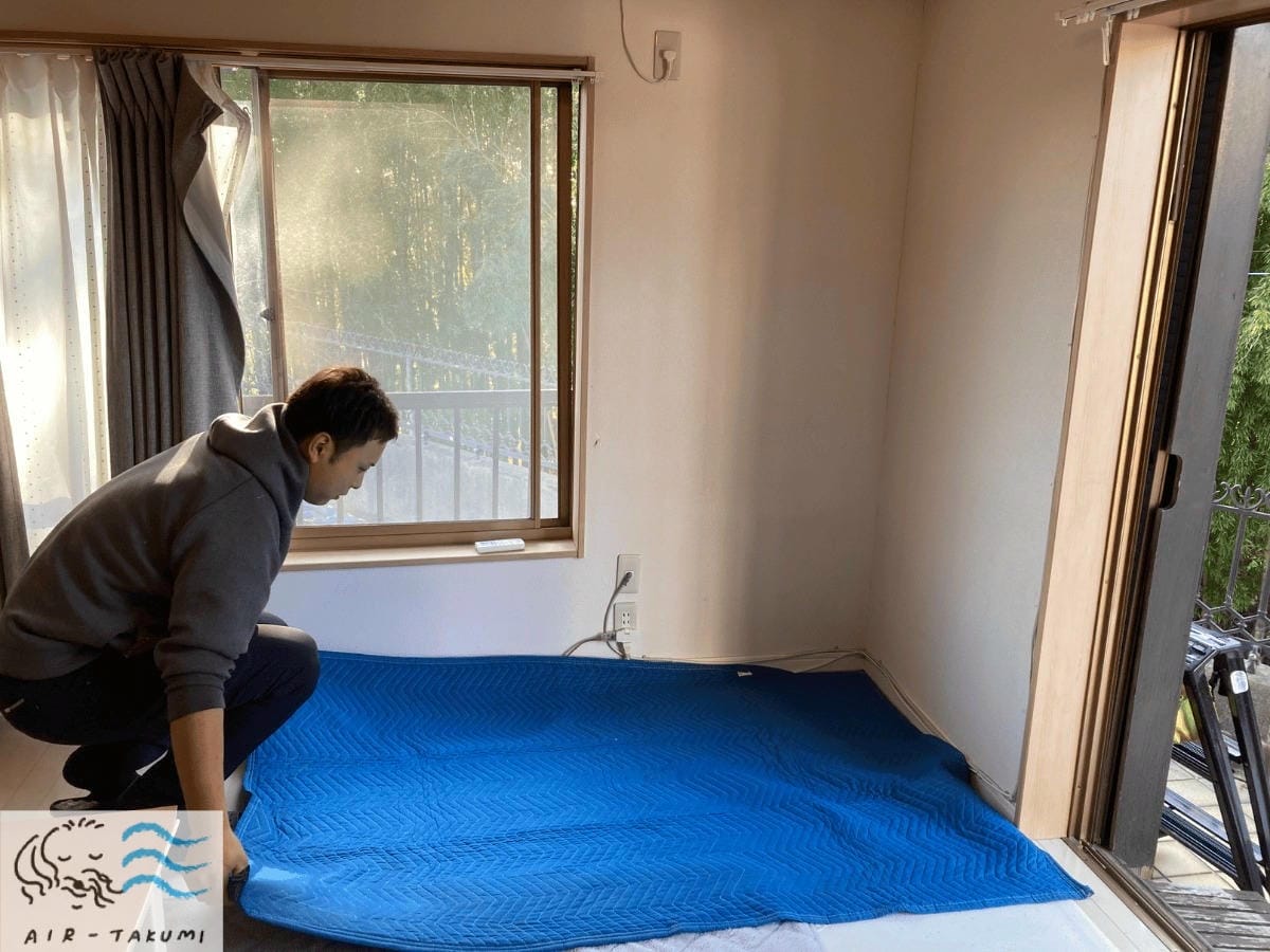 床に養生マットを敷いている様子